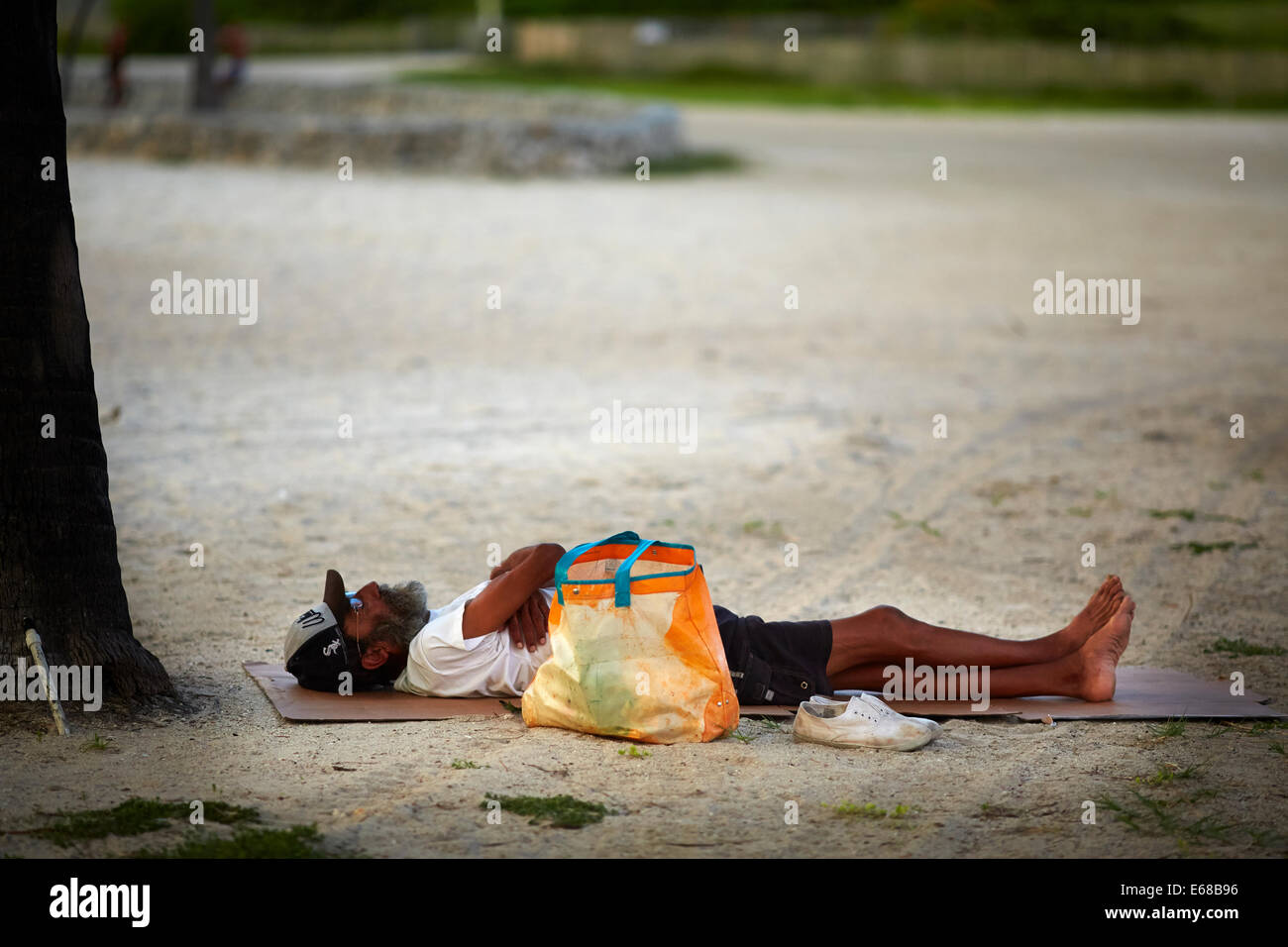 Miami in Florida USA a man sleep on the beach area around Ocean Drive. Stock Photo