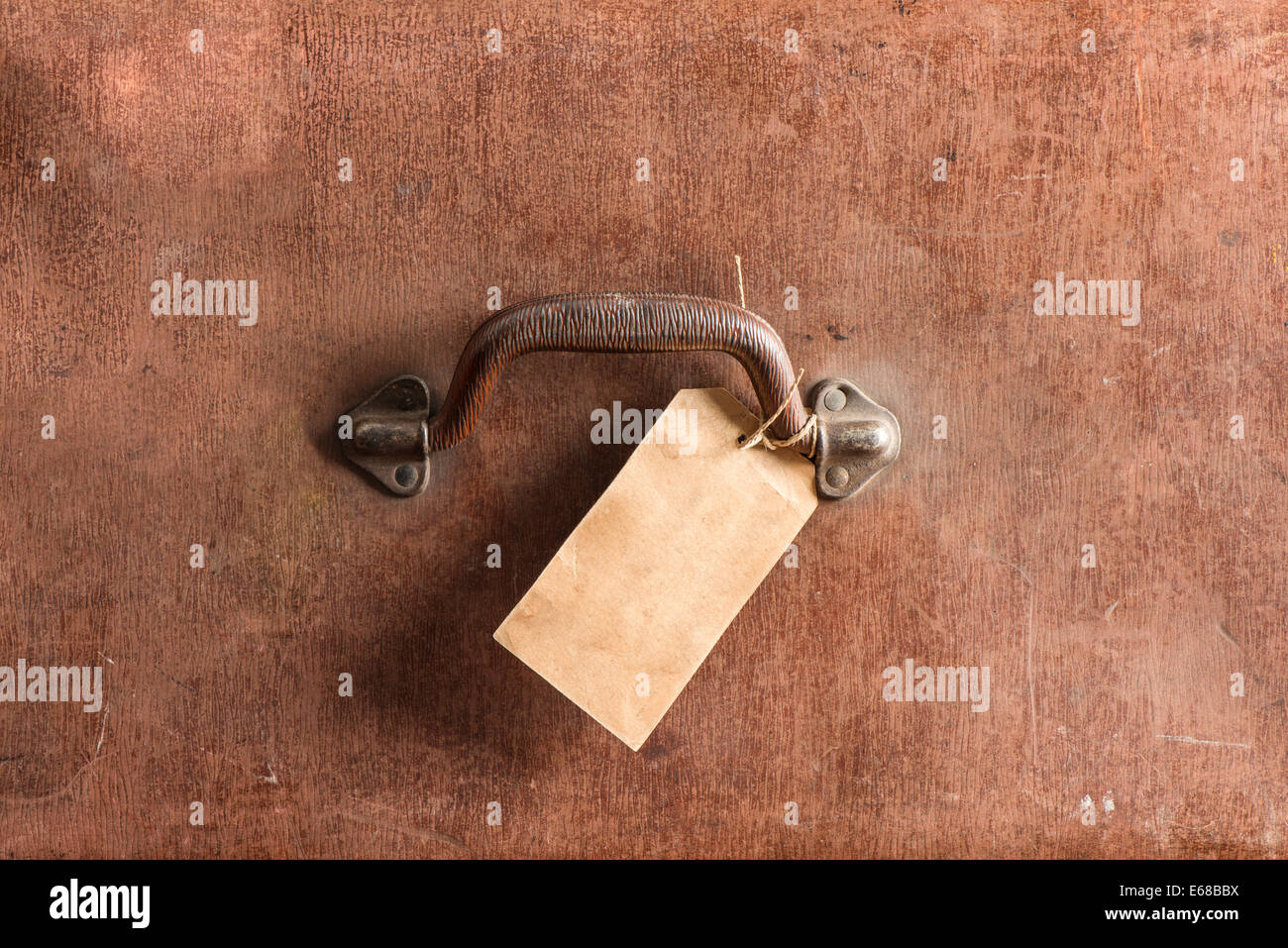 Close up of old brown leather bag. Detail of handle and luggage tag. Stock Photo