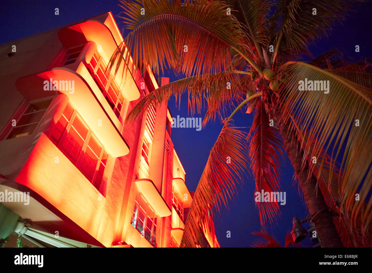 Art deco hotels and restaurants glow in the evening light on Ocean Drive in Miami, Florida USA Stock Photo