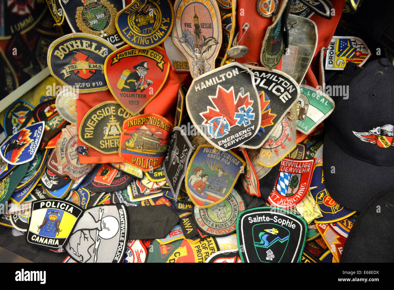 Fire Department and Police patches left at a 9/11 Memorial at Saint Paul's Church across from Ground Zero in New York City. Stock Photo