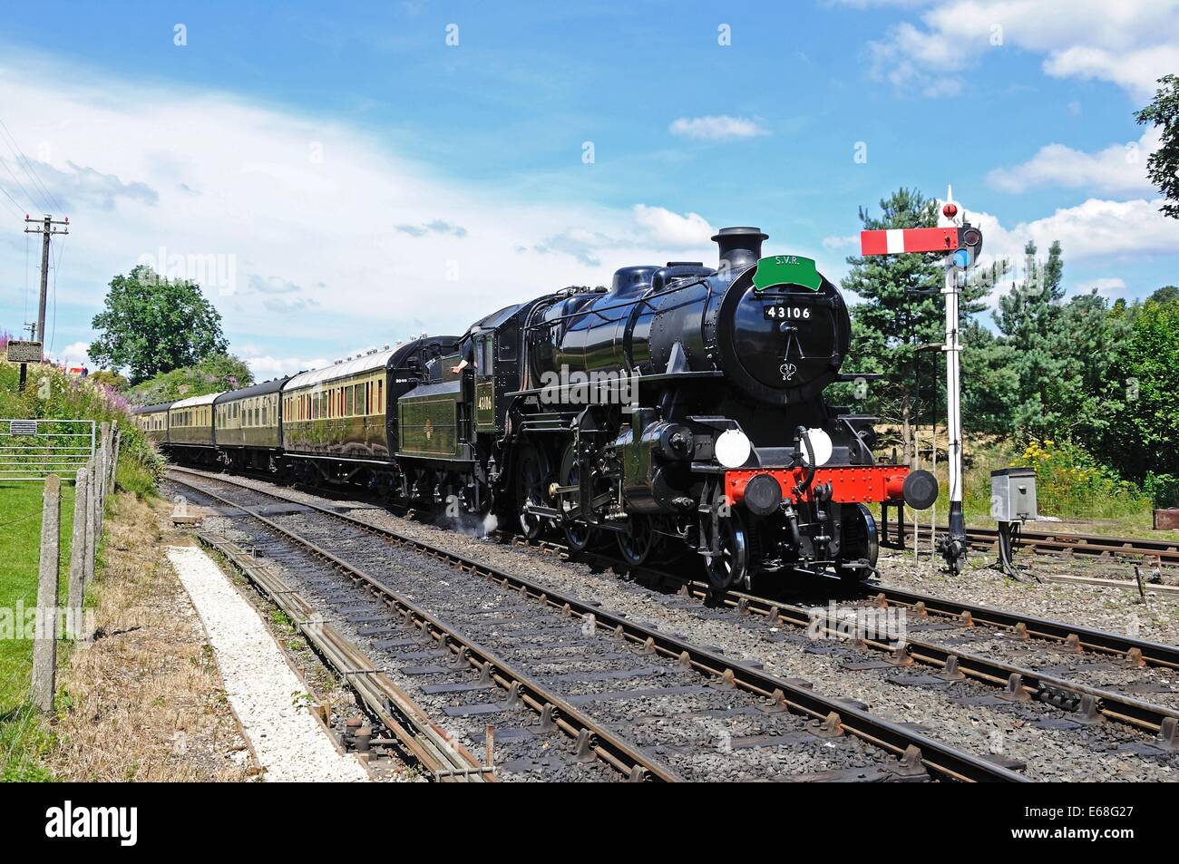 Steam Locomotive Ivatt Class 4 2-6-0 number 43106 in British Rail Black approaching the railway station, Arley, UK. Stock Photo
