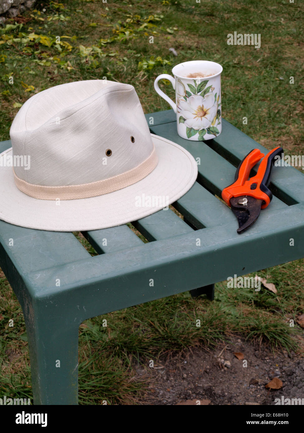 Gardeners hat, Secateurs and mug of tea, UK Stock Photo