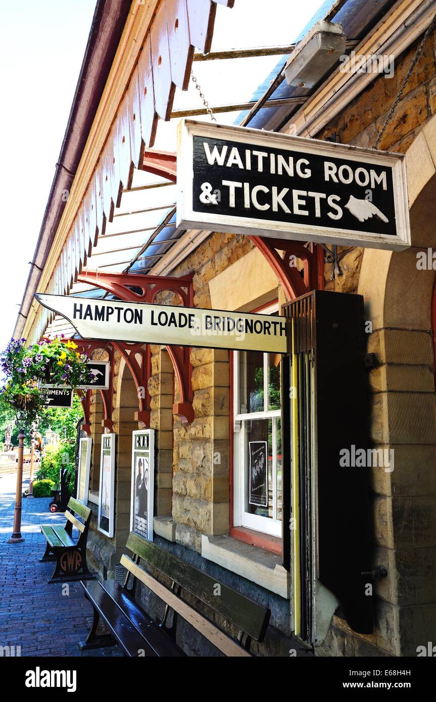View along the railway platform showing the next train pointer destination and waiting room sign, Severn Valley Railway, Highley Stock Photo