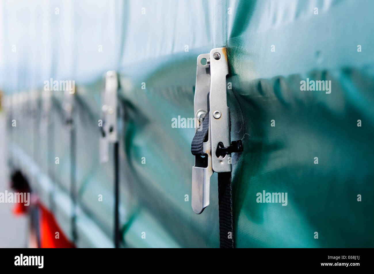 Tie-down straps and shackles on a curtain-sided trailer (Tautliner) Stock Photo