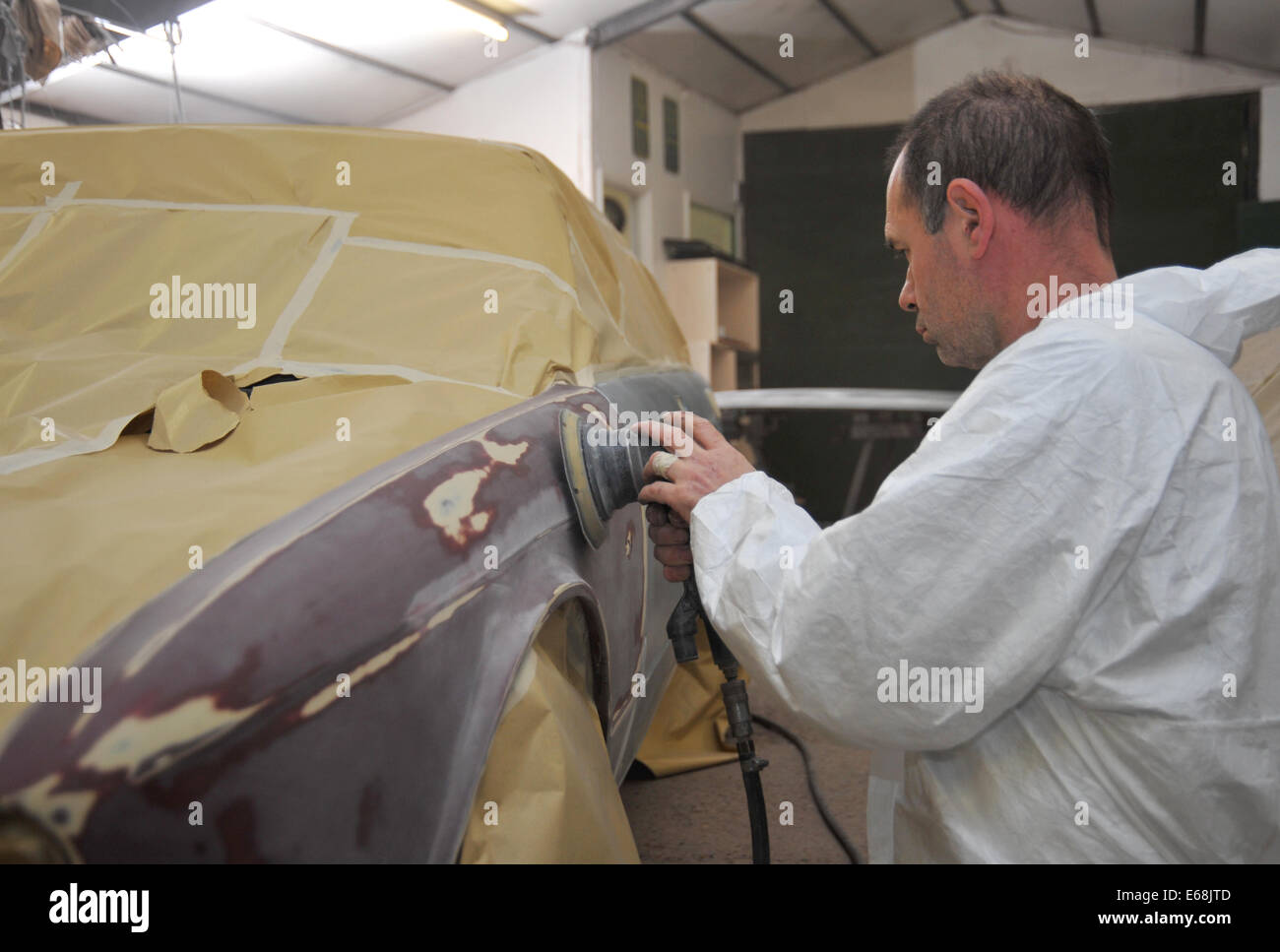 Car repair and restoration sanding old paint work ready for painting