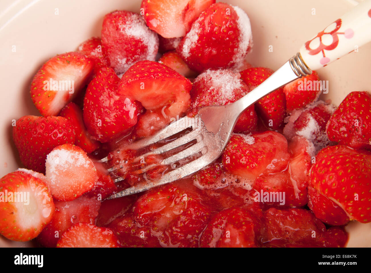 mixing strawberries with sugar in the bowl Stock Photo - Alamy