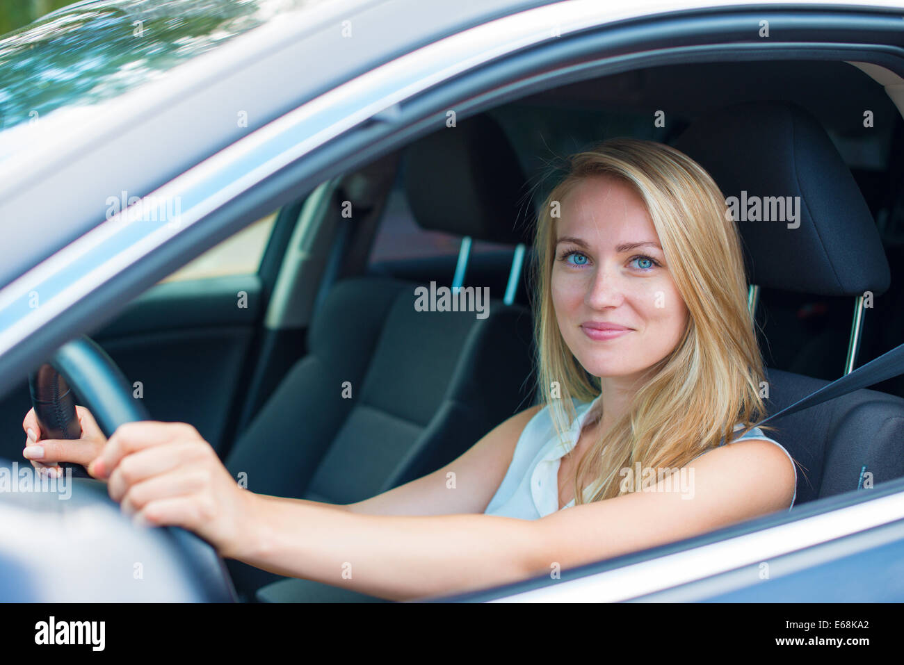 Beautiful young woman driving a car Stock Photo - Alamy