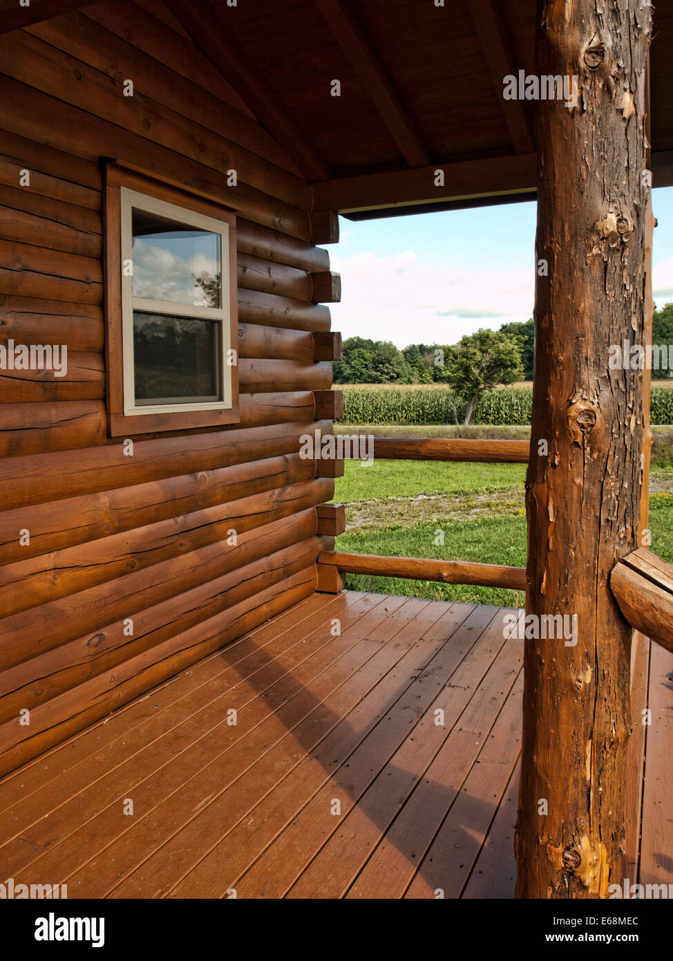 log cabin with view of a corn field Stock Photo
