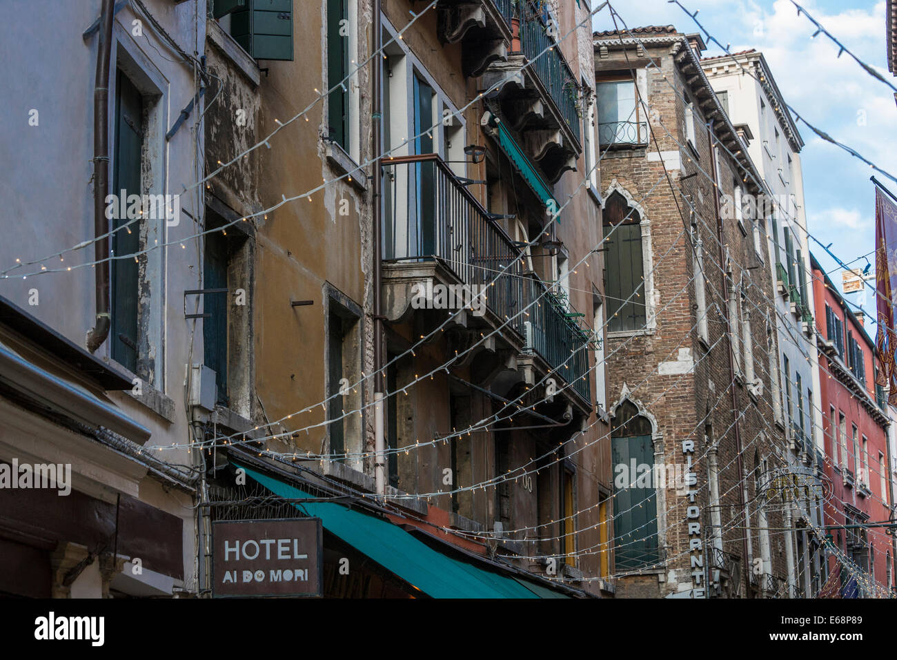 String of lights adorn the shops across a main pedestrian thoroughfare in Venice. Stock Photo