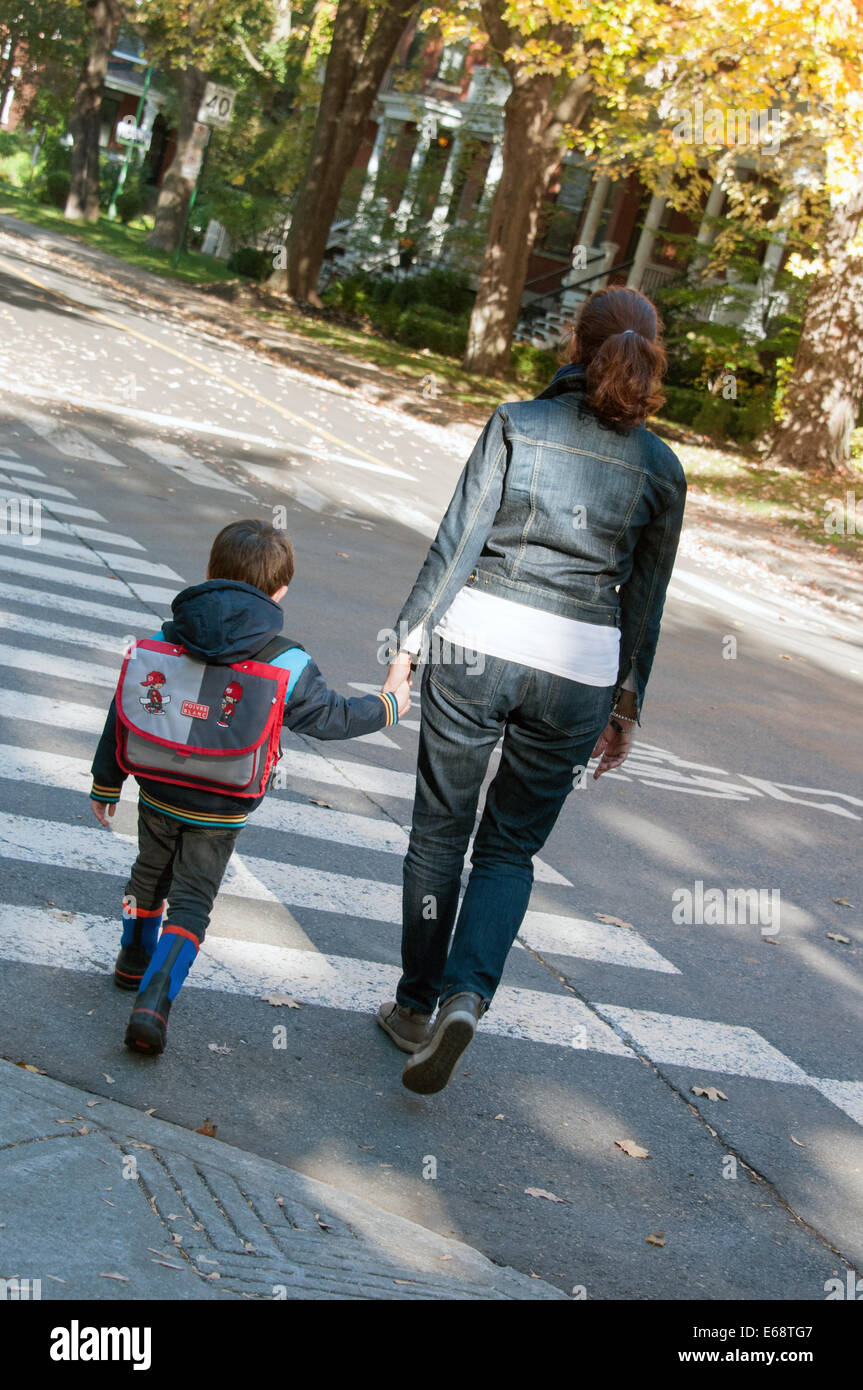 Adult and child walking to school Stock Photo
