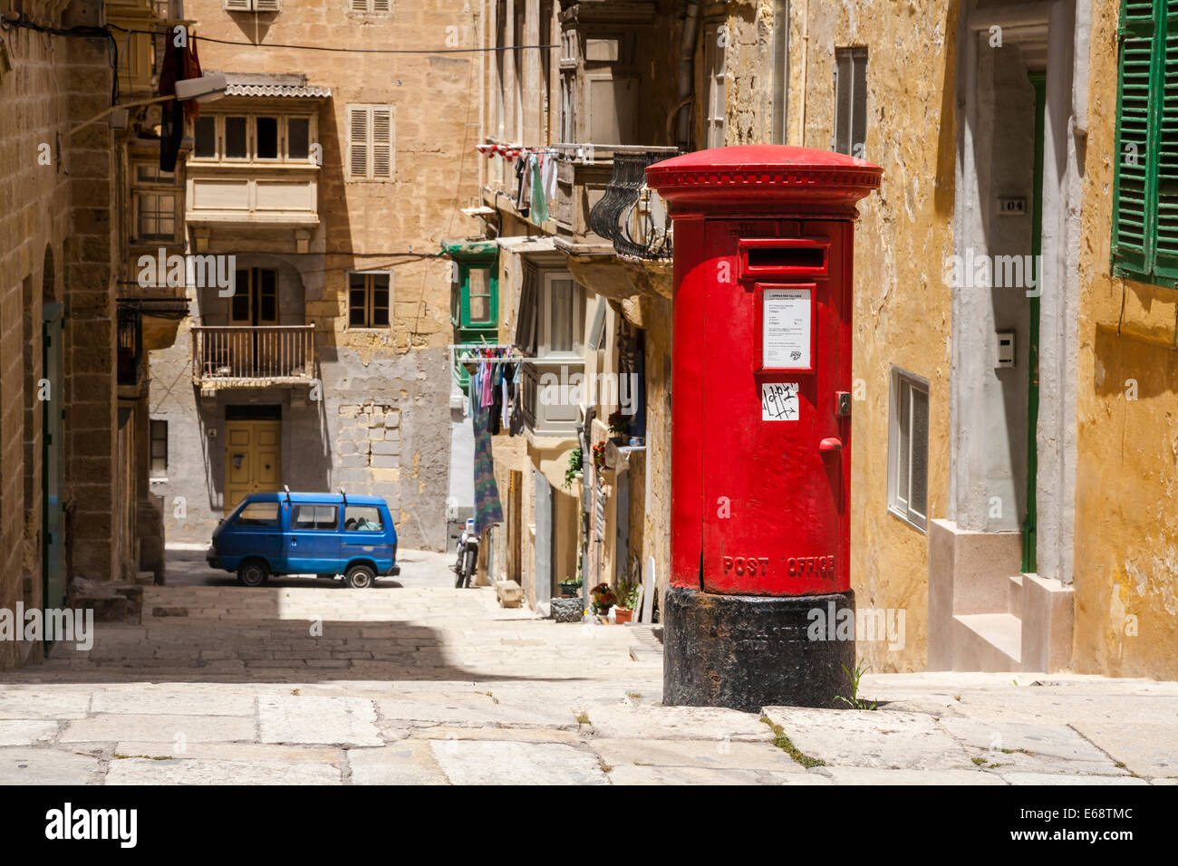 Old red British postbox  on a Valletta street, Island of Malta. Stock Photo