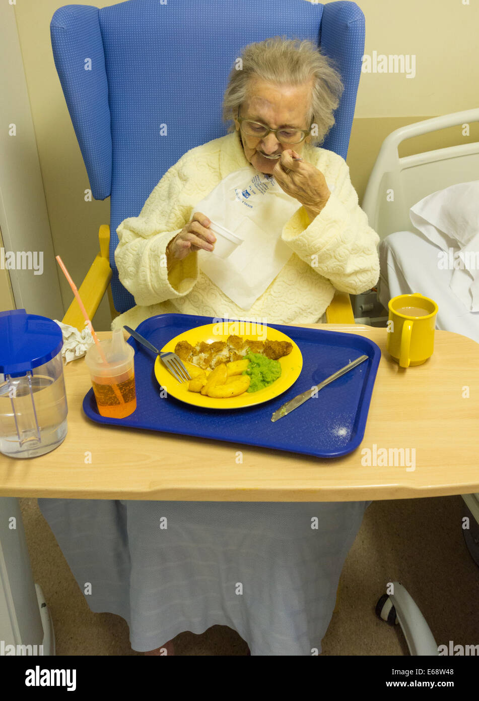 Elderly patient in her eating fish and chips in NHS hospital in England, UK Stock Photo