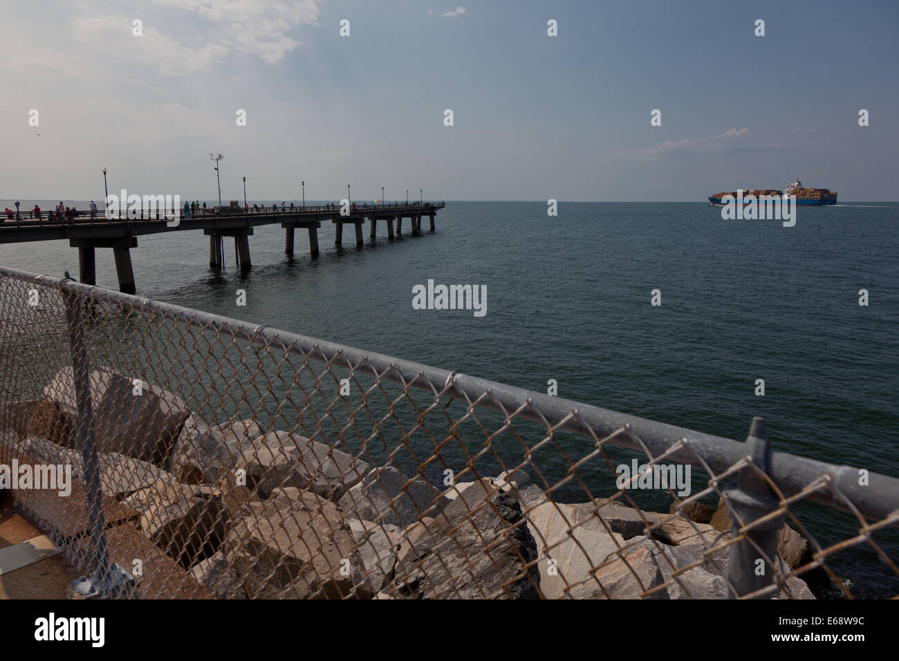 View over the water from South Thimble Island at the Sea Gull Pier on the Chesapeake bay bridge in Virginia at cargo ships passing over the tunnel Stock Photo