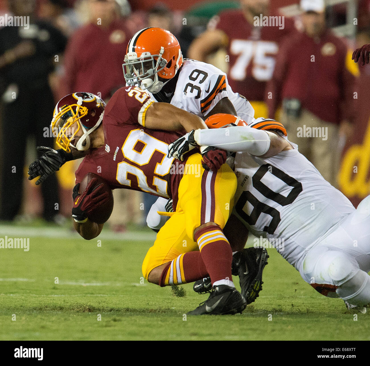 Landover, MD., US. 18th Aug, 2014. Washington Redskins running back Roy Helu (29) is tackled by Cleveland Browns defensive end Billy Winn (90) during the first half of their NFL preseason game at FedEx Field in Landover, MD Monday, August 18, 2014. Credit:  Harry Walker/Alamy Live News Stock Photo