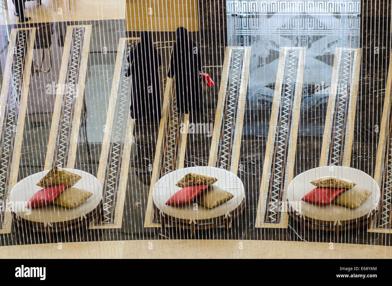 Arab muslim women in the entrance lobby lounge seats of the Raffles Dubai Hotel Dubai, United Arab Emirates UAE. Stock Photo