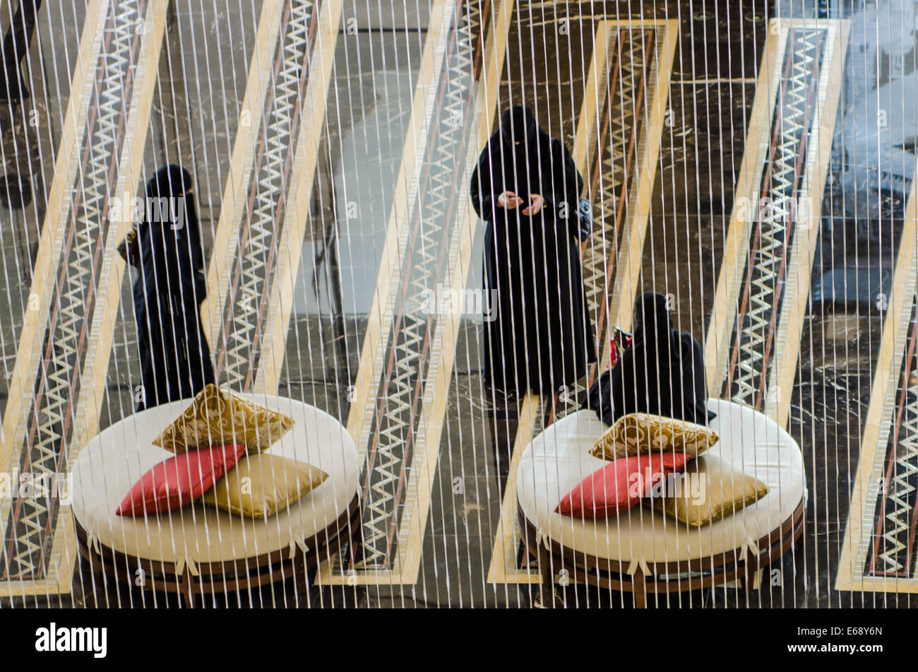 Arab muslim women in the entrance lobby lounge seats of the Raffles Dubai Hotel Dubai, United Arab Emirates UAE. Stock Photo