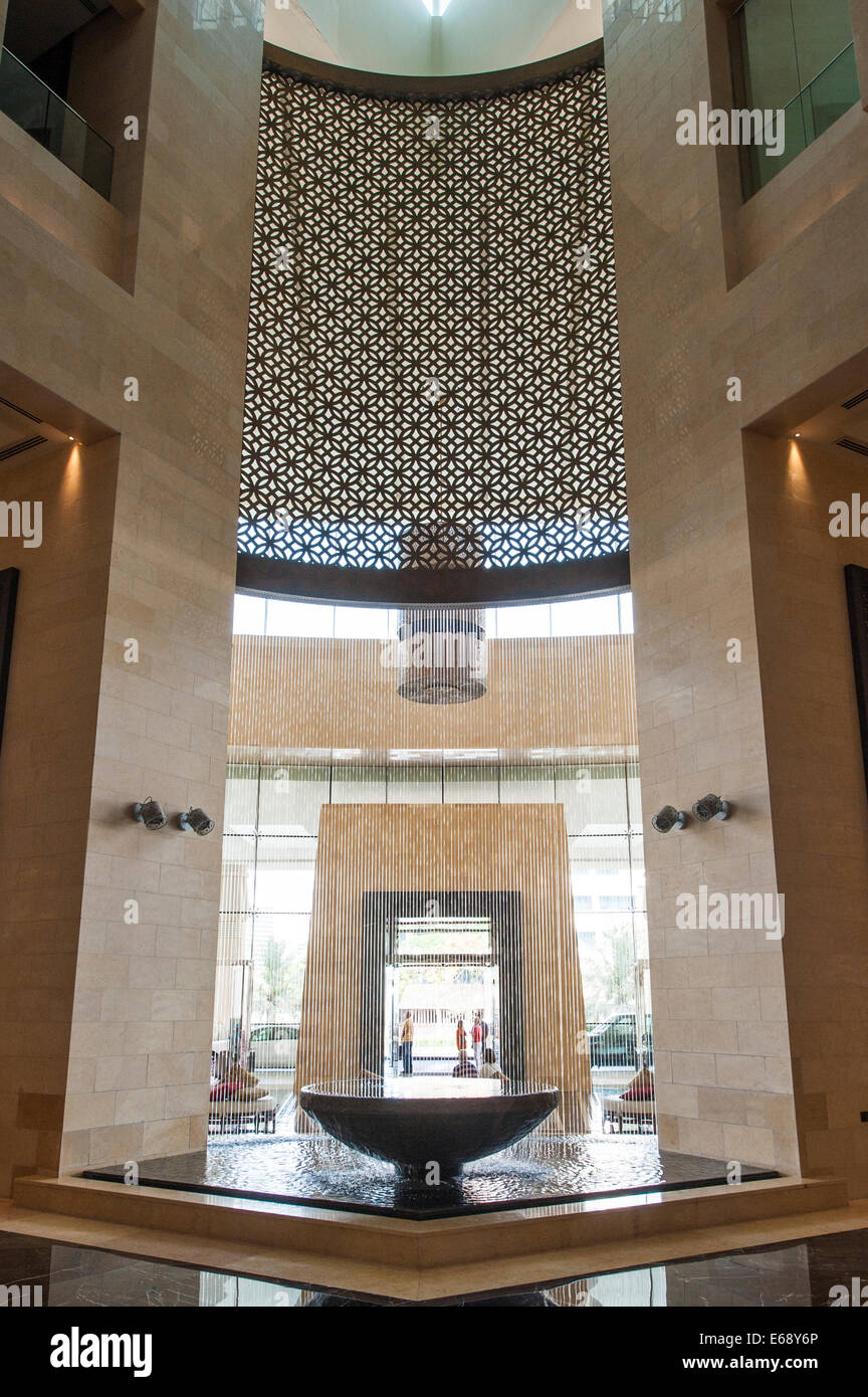 Entrance lobby lounge fountain seats of the Raffles Dubai Hotel Dubai, United Arab Emirates UAE. Stock Photo