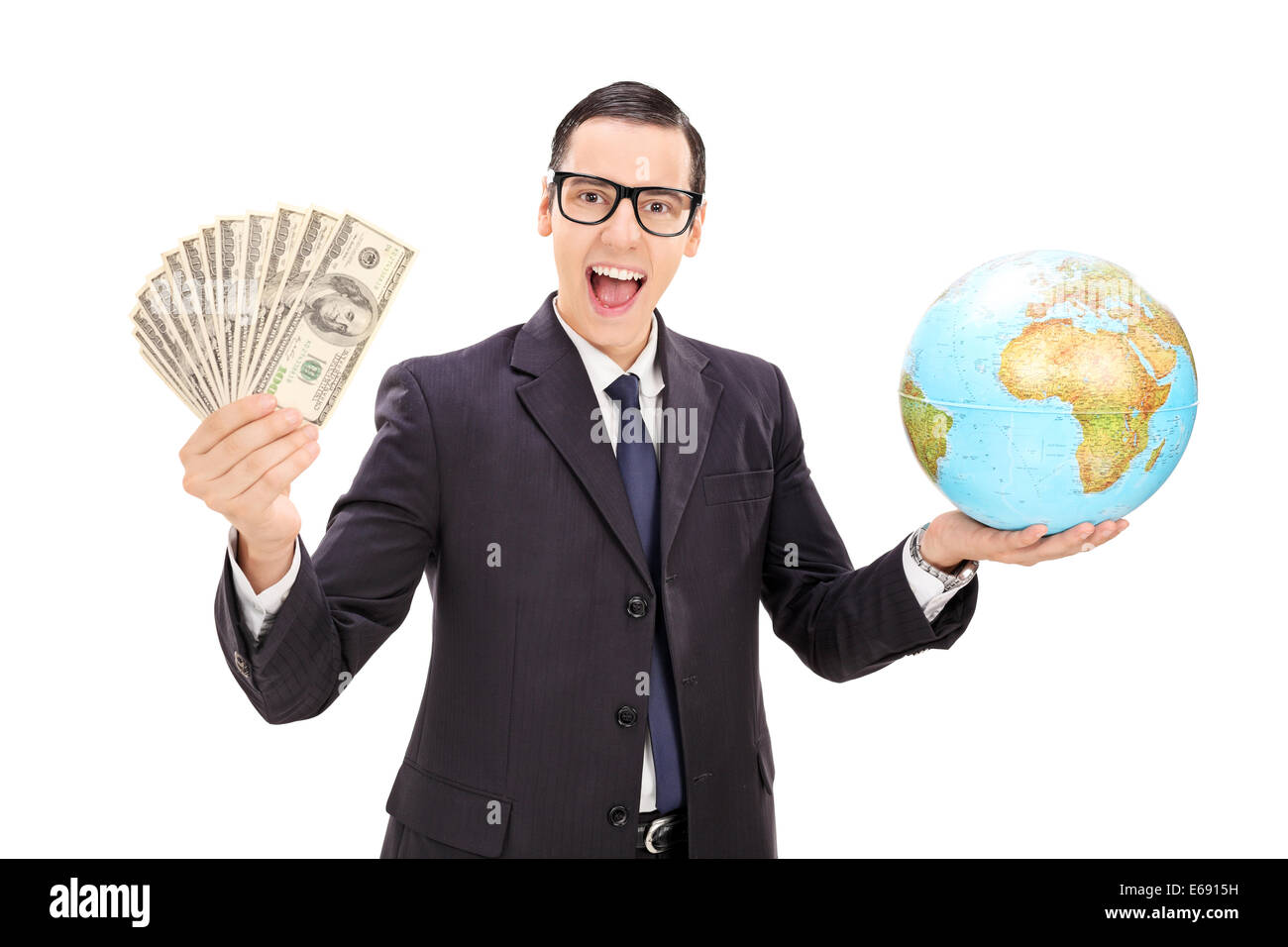 Wealthy businessman holding money and a globe isolated on white background Stock Photo