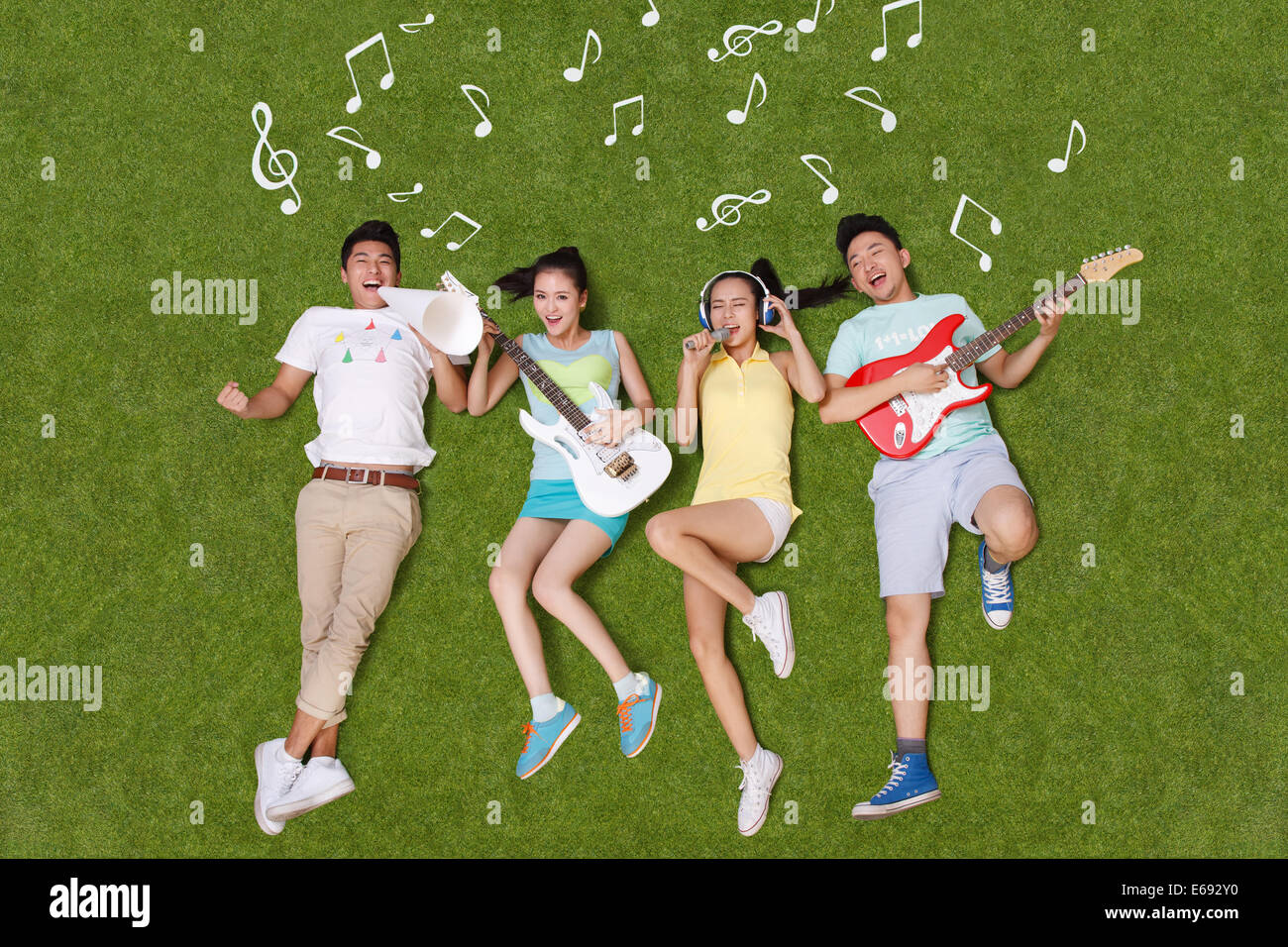 Young people on grass playing musical instruments Stock Photo - Alamy