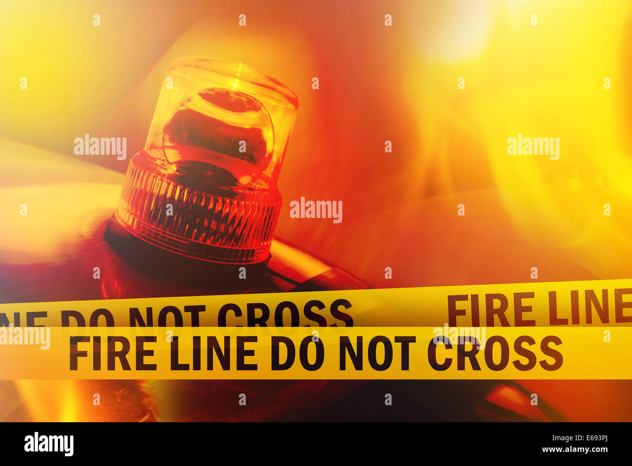 Fire Line Do Not Cross Yellow Headband Tape and Orange flashing and revolving light. Stock Photo