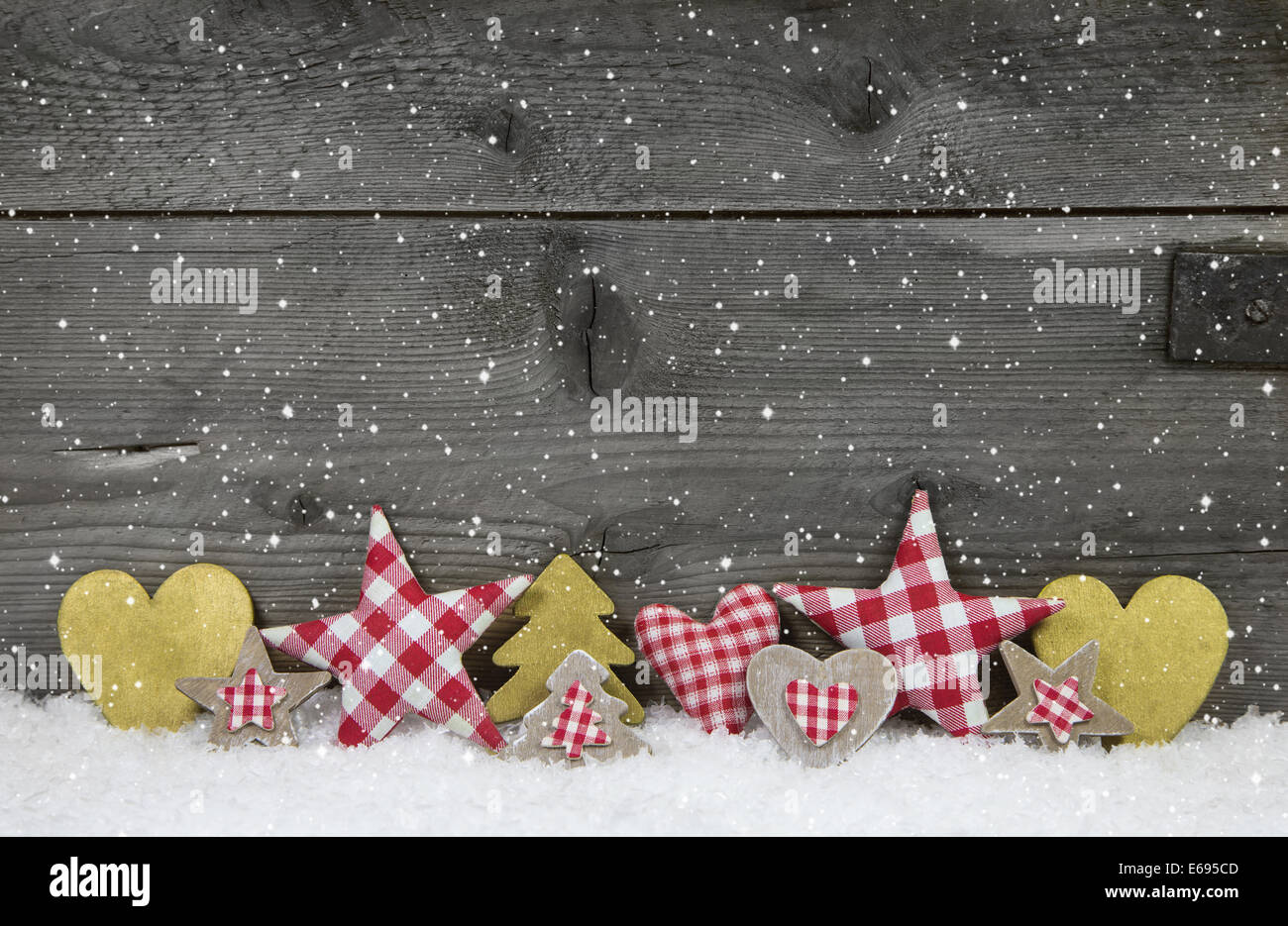 Christmas decoration in red white checked with gold on wooden background. Stock Photo