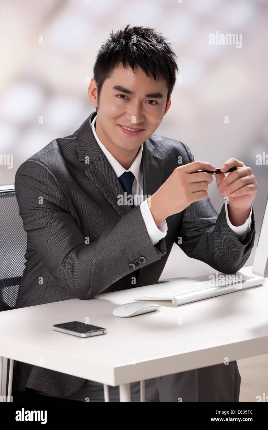 Young businessman using laptop Stock Photo - Alamy