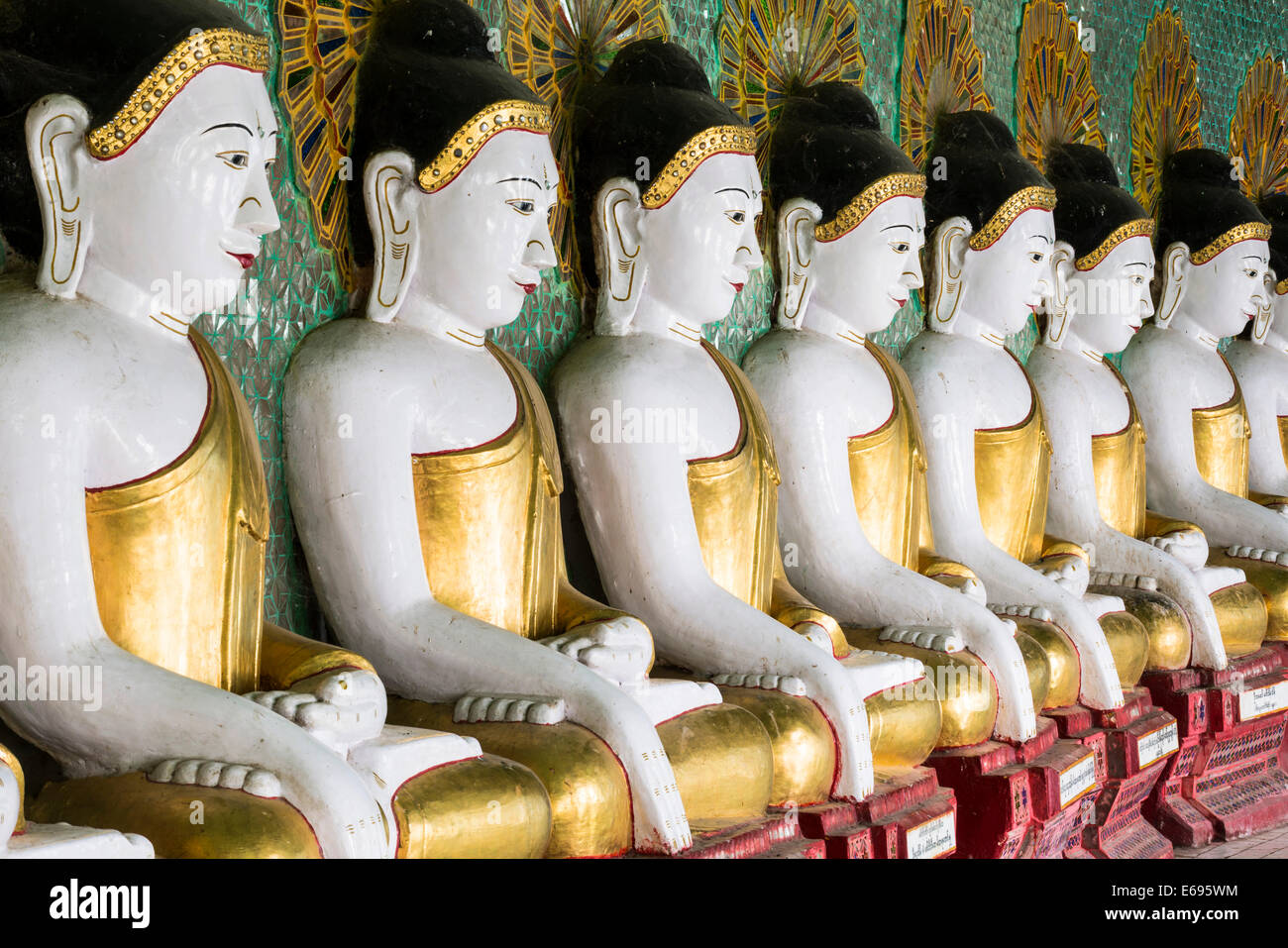 Many seated Buddha sculptures, walls decorated with glass mosaics, Umin
