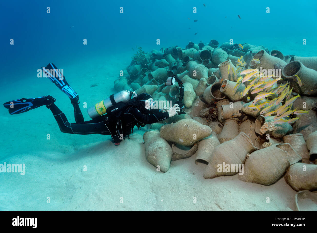 Underwater photographer photographing school of fish on amphora, Red Sea, Makadi Bay, Hurghada, Egypt Stock Photo