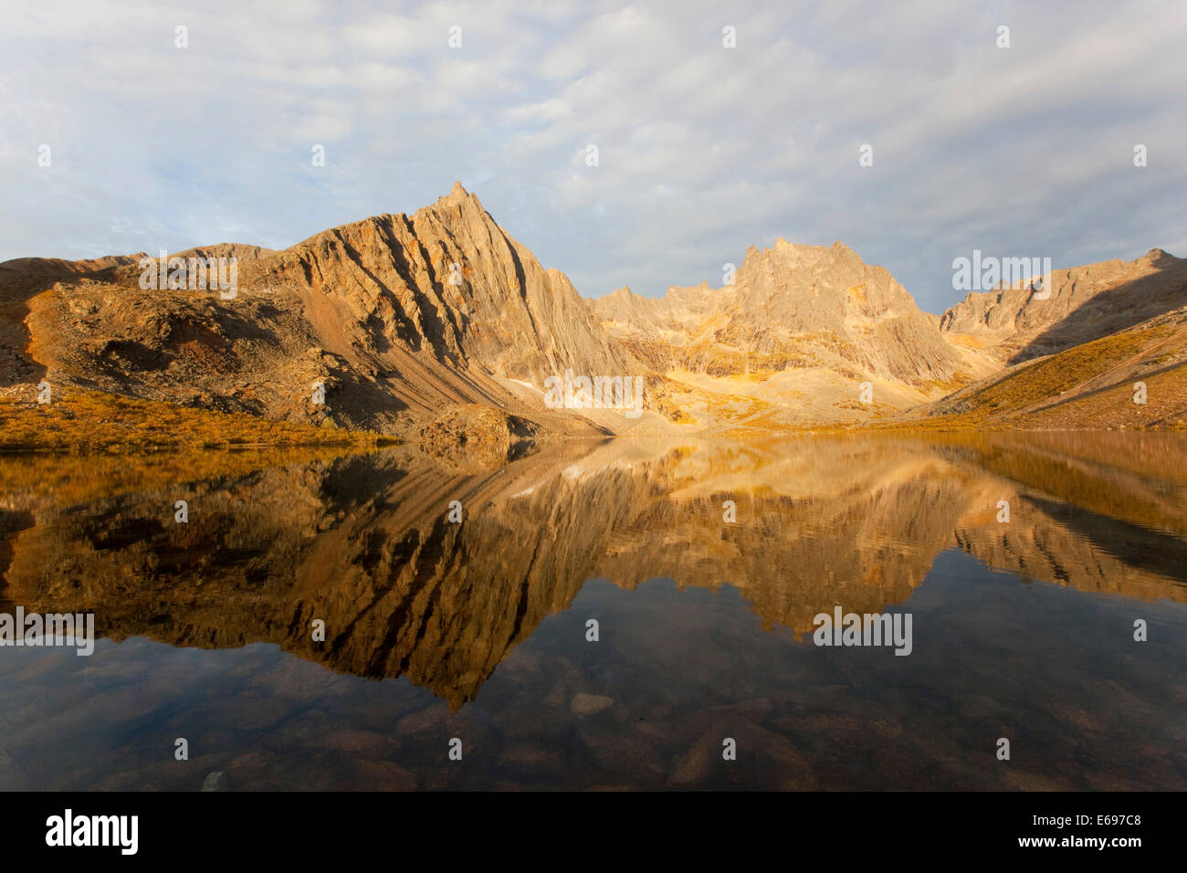 Reflection of Mount Monolith in calm Grizzly Lake, Tombstone Mountains Territorial Park, Yukon Territory, Canada Stock Photo