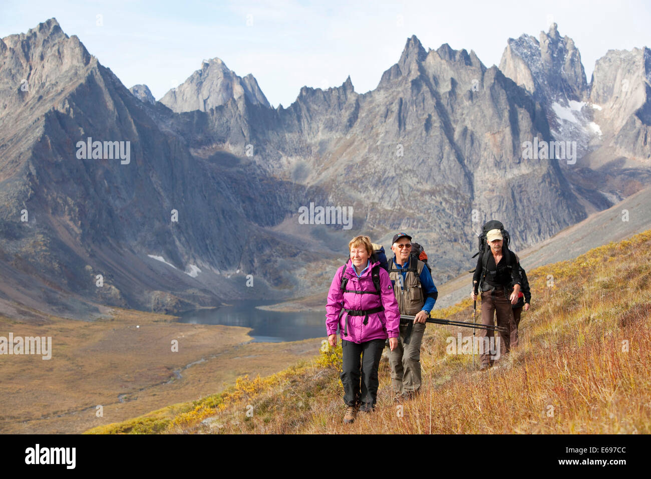 People hiking in arctic or subalpine tundra, Mount Monolith behind, Indian summer, Tombstone Mountains Territorial Park Stock Photo