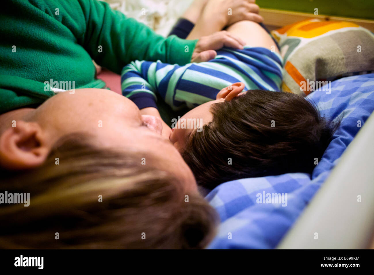 Mother and son napping in bed Stock Photo