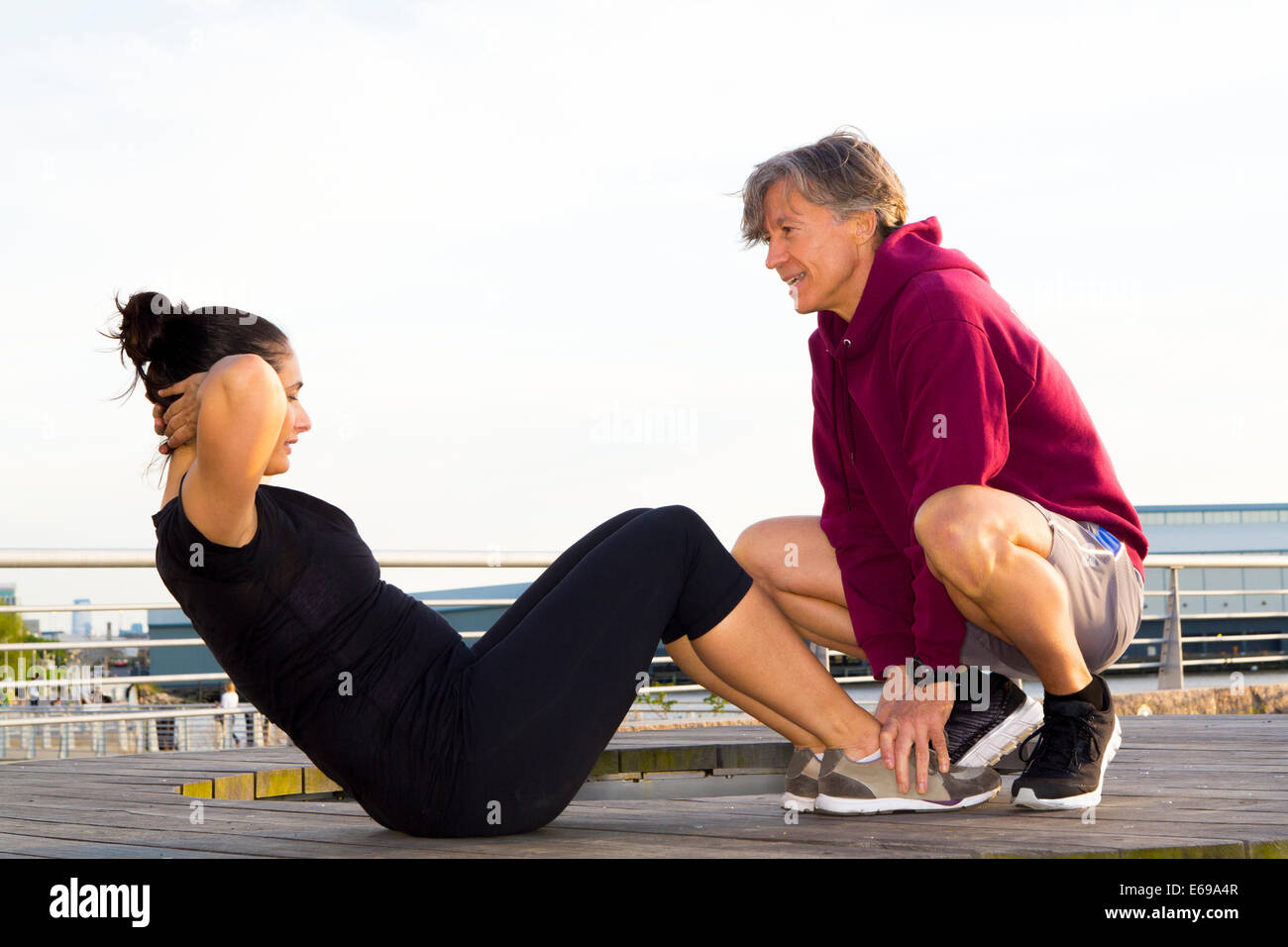 Couple exercising in waterfront park Stock Photo