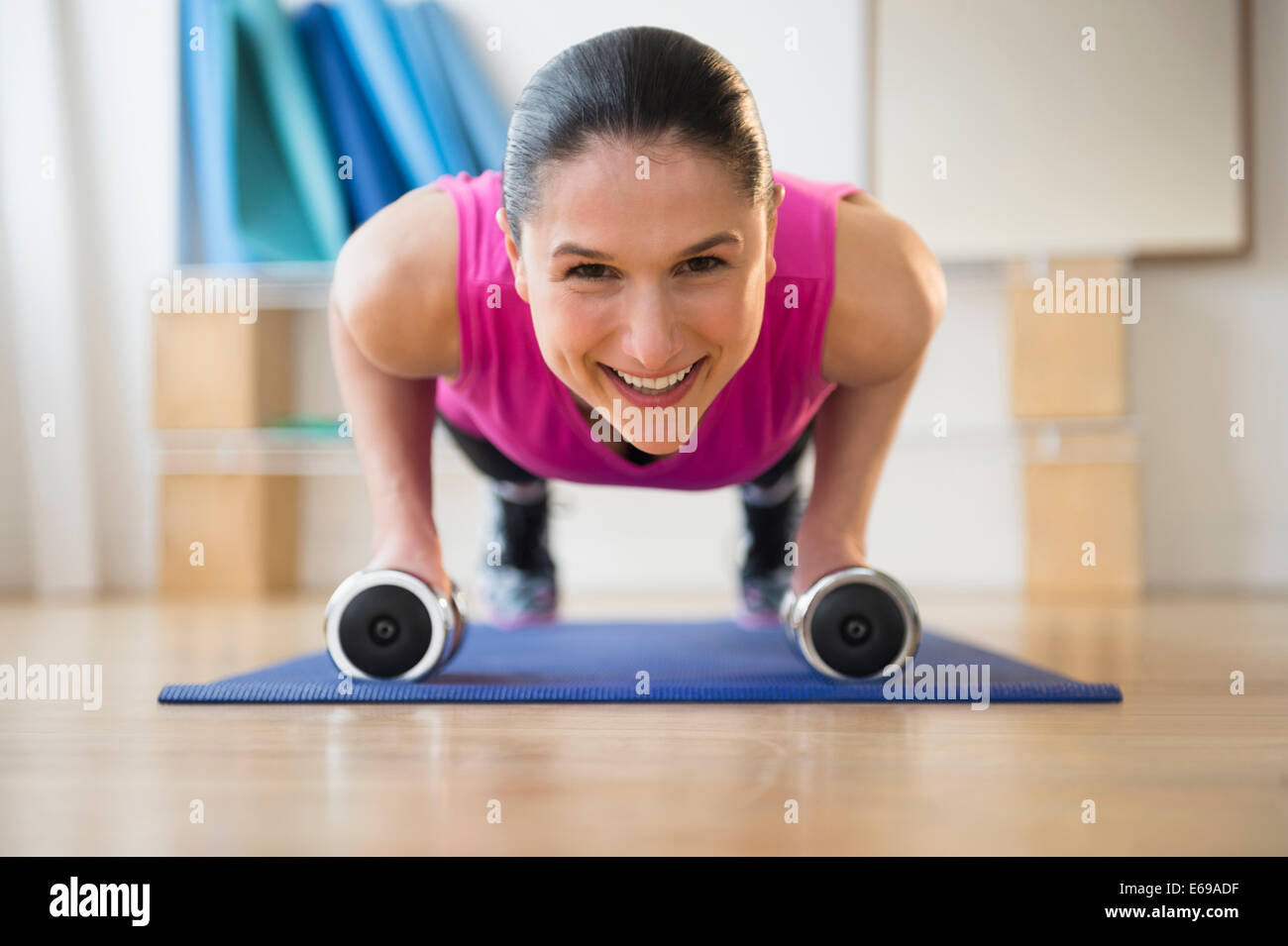 Caucasian woman doing push ups on yoga mat Stock Photo Alamy
