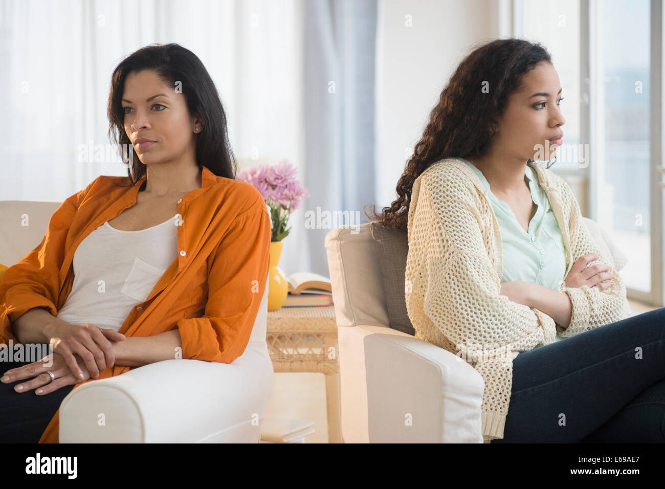 Mother and daughter arguing in living room Stock Photo