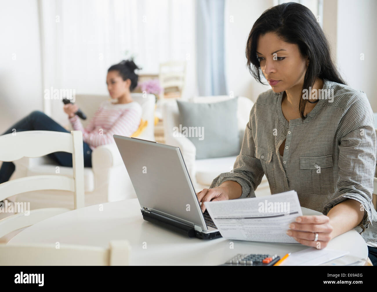 Woman paying bills online Stock Photo