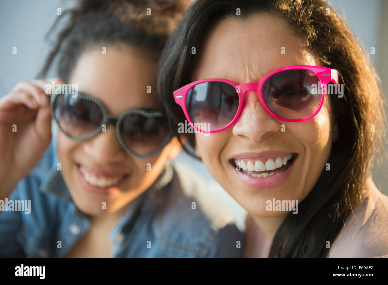 Mother and daughter wearing novelty sunglasses Stock Photo