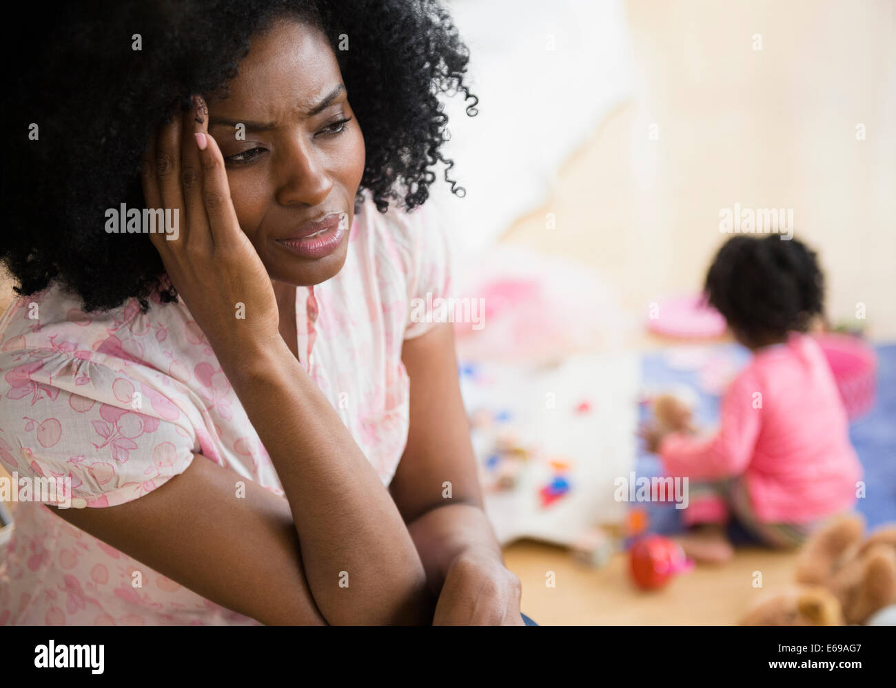 Frustrated mother rubbing her temples Stock Photo
