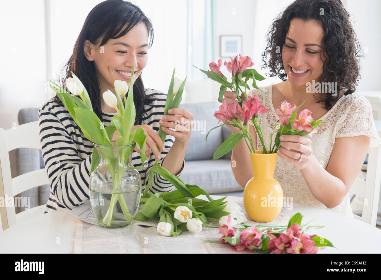 Women arranging flowers together Stock Photo