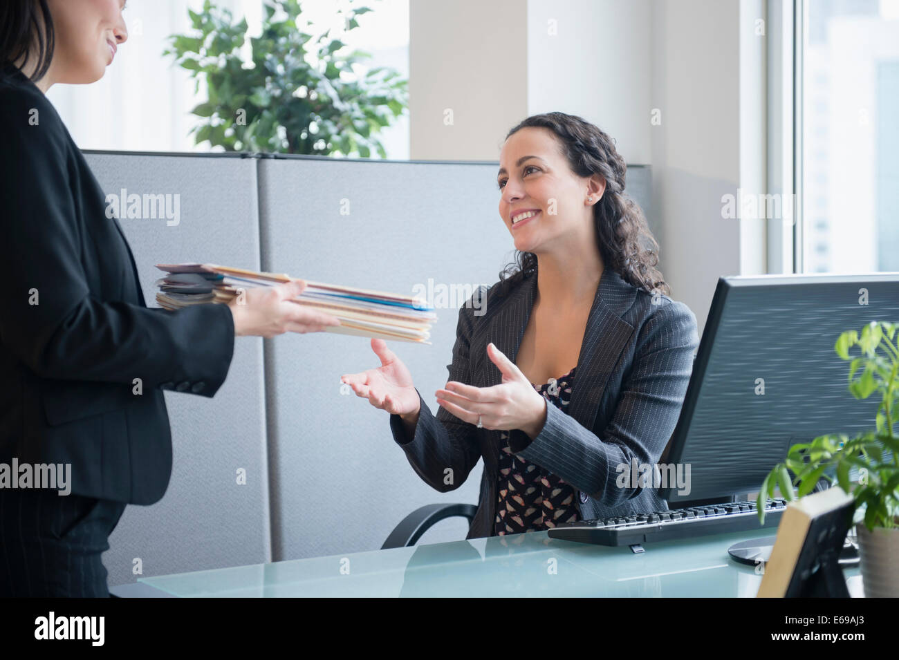 Businesswomen working together in office Stock Photo - Alamy