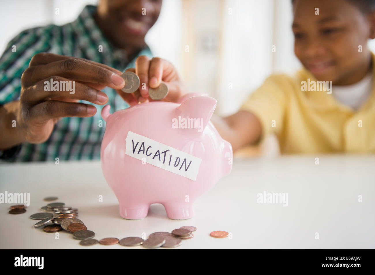 Father and son saving coins for vacation Stock Photo