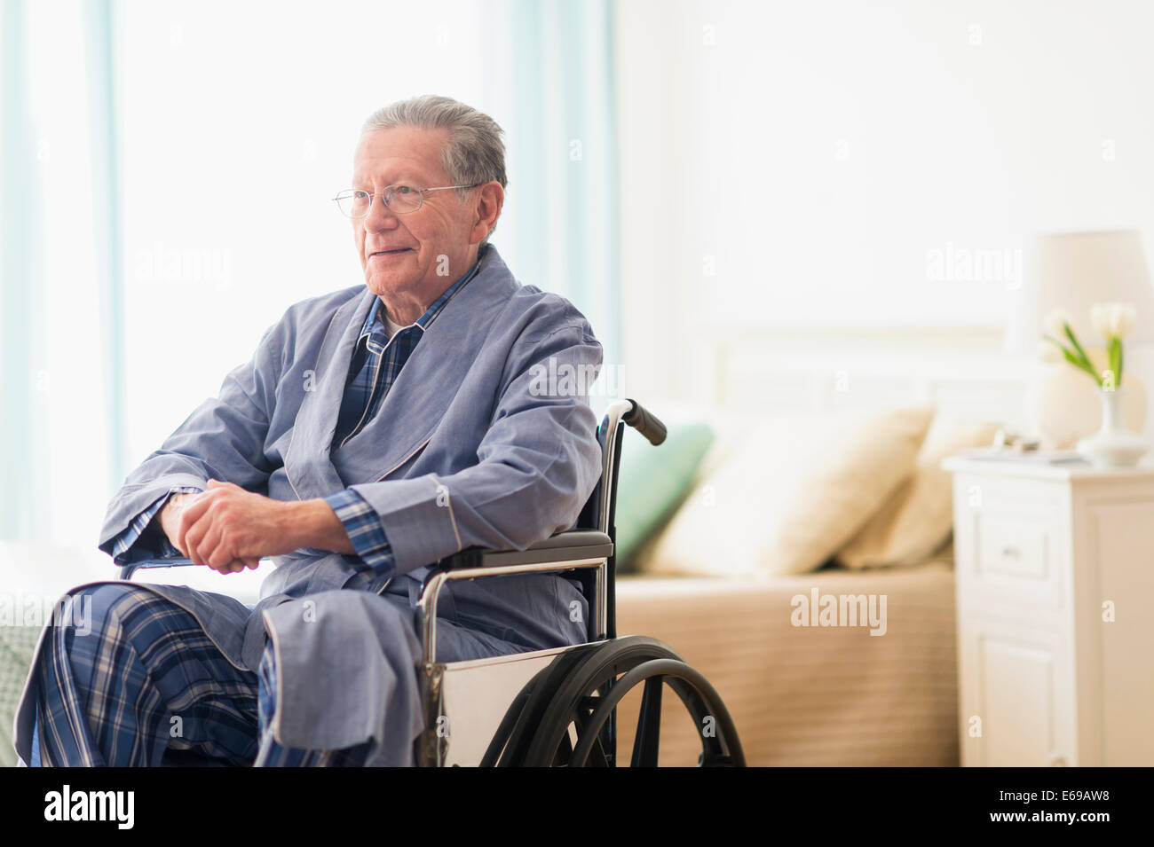 Senior Caucasian man sitting in wheelchair Stock Photo