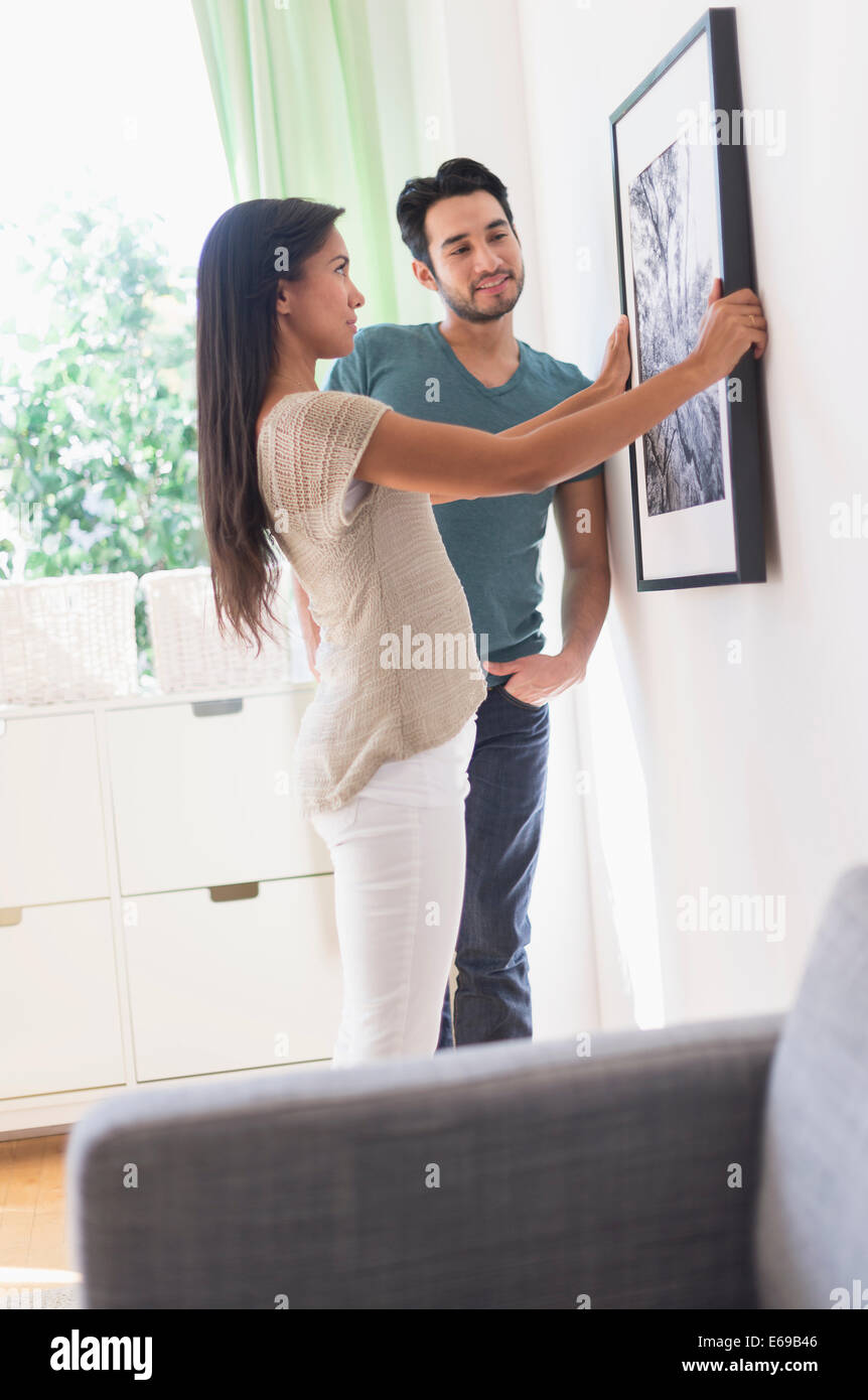 Couple hanging picture together Stock Photo