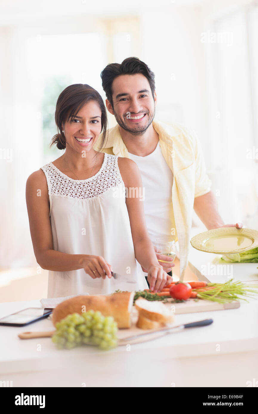 Couple cooking together in kitchen Stock Photo