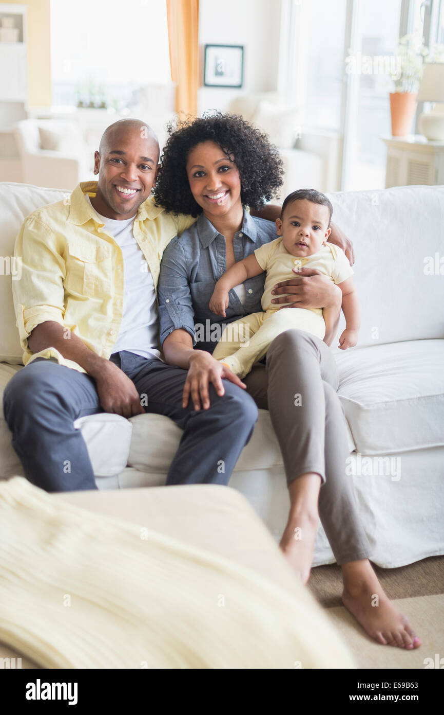 Family smiling together in living room Stock Photo