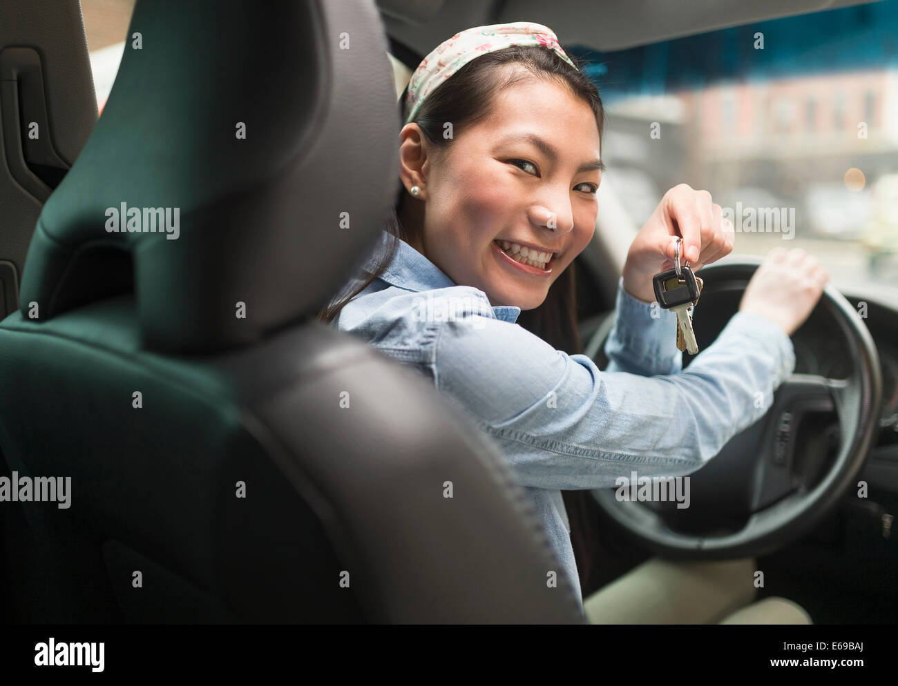 Mixed race teenage girl holding keys to car Stock Photo. 