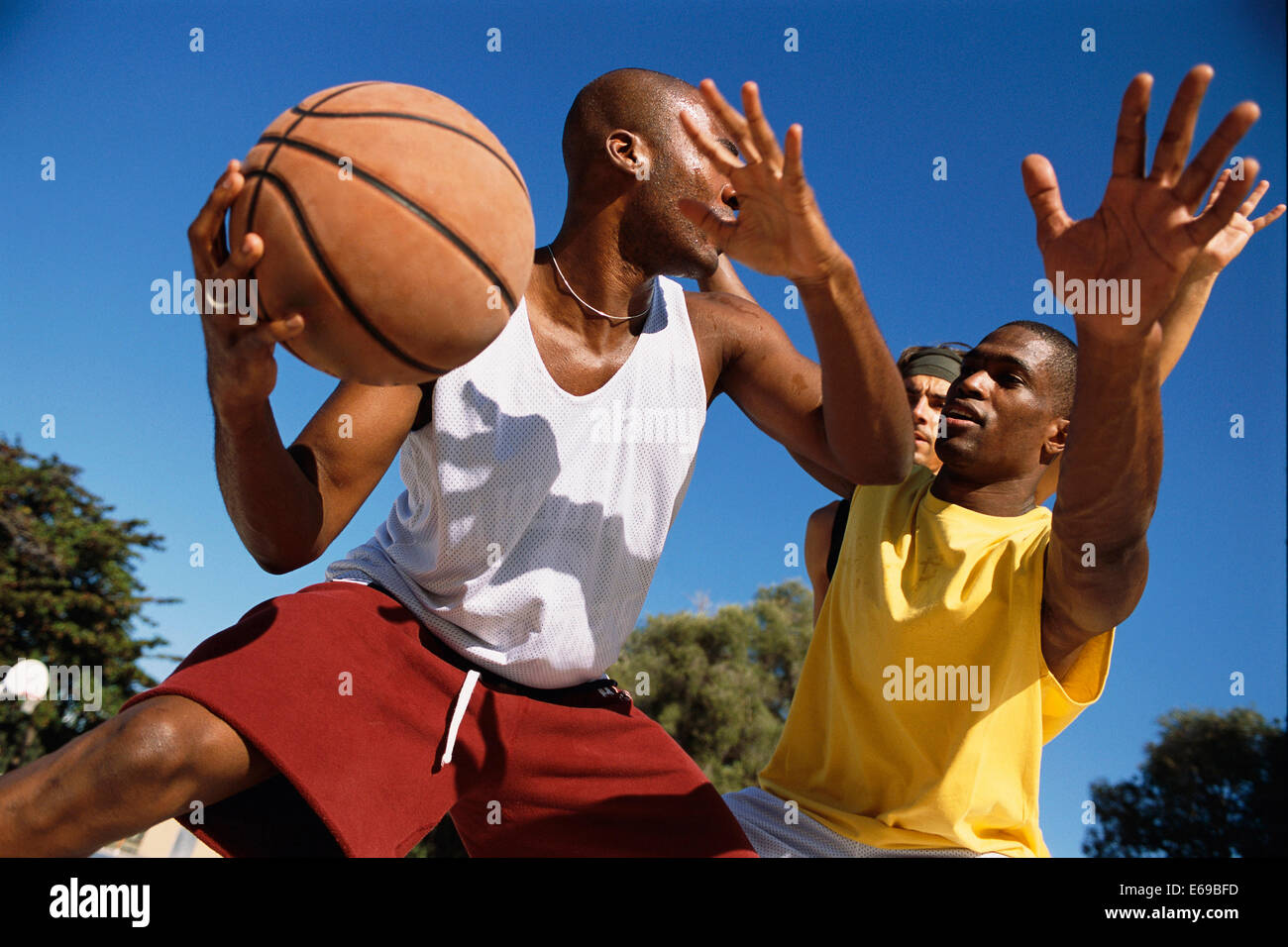 Men playing basketball outdoors Stock Photo Alamy