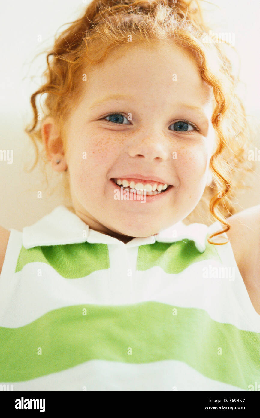 Smiling girl laying on sofa Stock Photo - Alamy