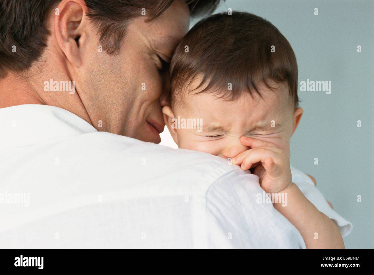 Father comforting crying baby Stock Photo