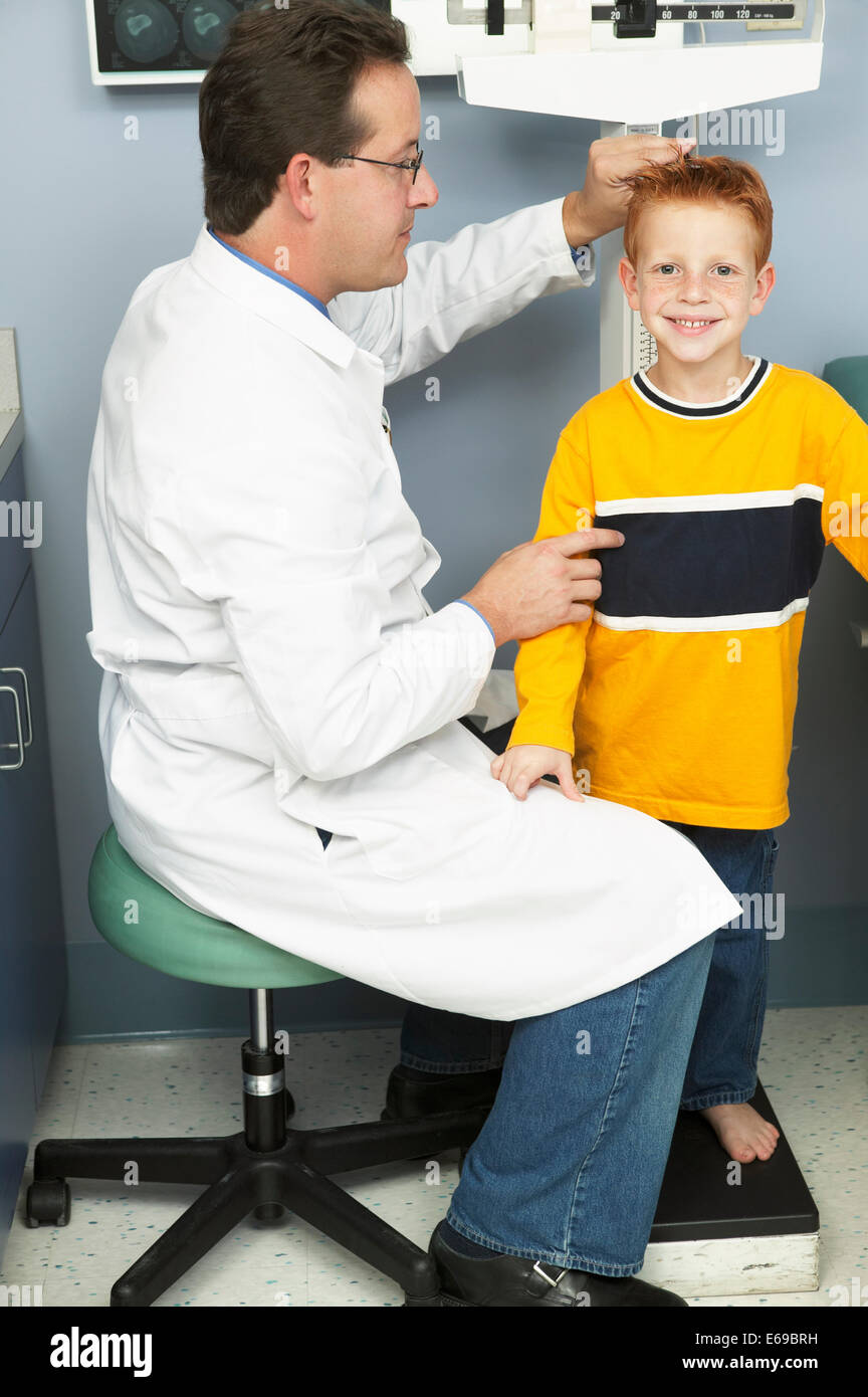 Doctor measuring boy's height in office Stock Photo Alamy