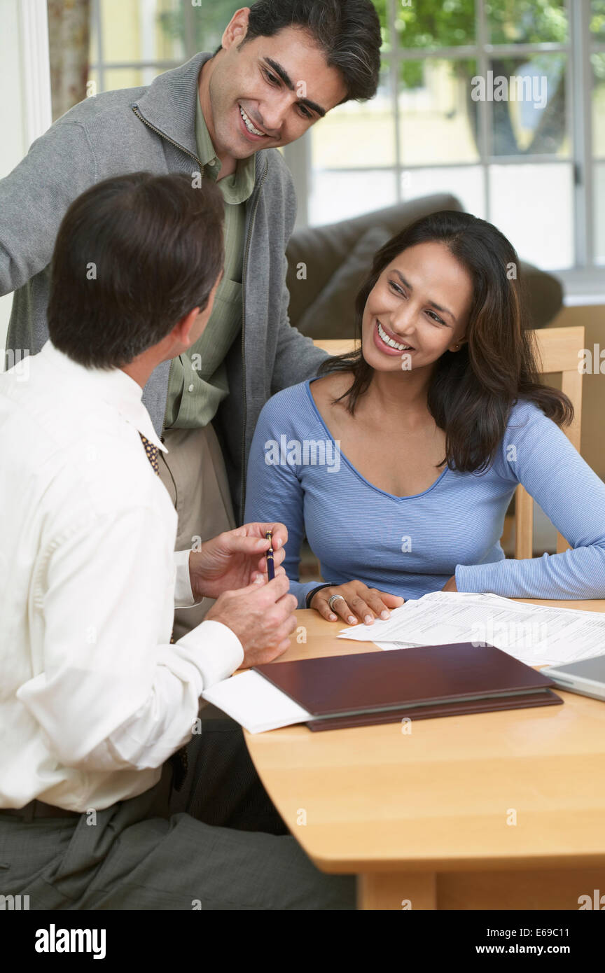 Couple and businessman examining papers Stock Photo